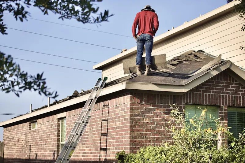 Professional roofer working on a residential roof in Long View